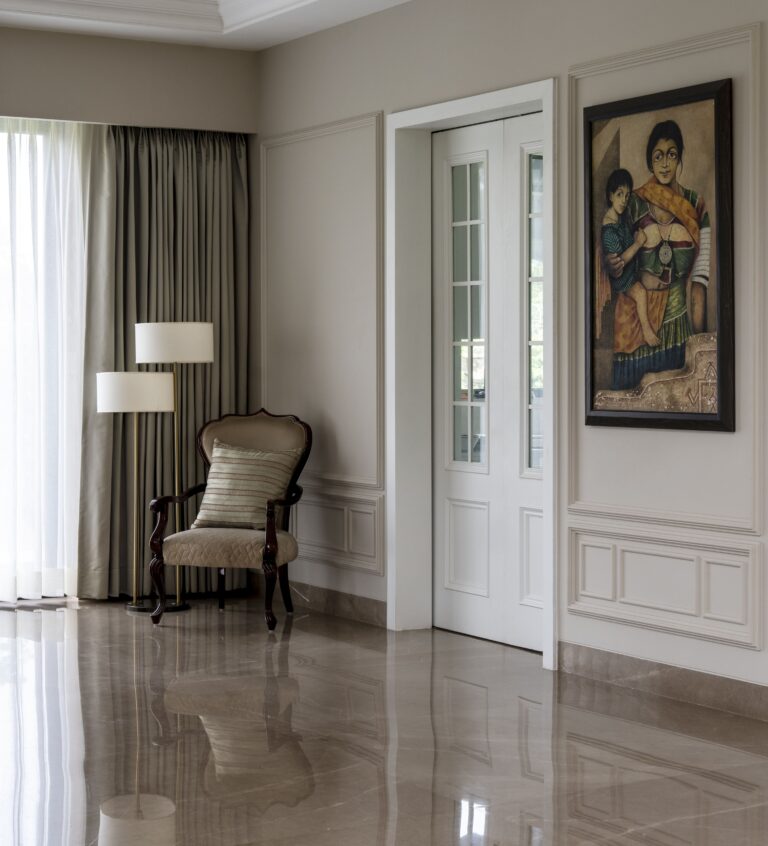 Detail view of a corner of the foyer with the kitchen entry door — interior design by Pochē Aesthetics, Delhi NCR