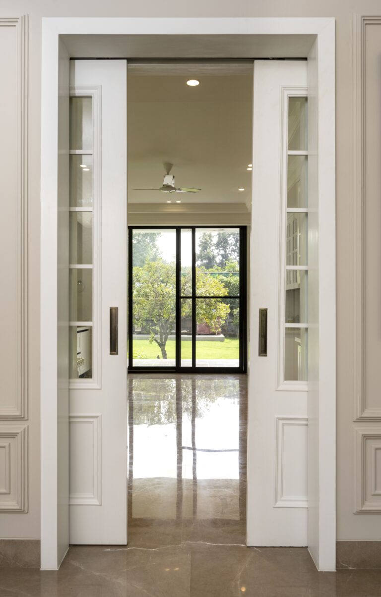 View of the french pocket door for the kitchen — interior design by Pochē Aesthetics, Delhi NCR