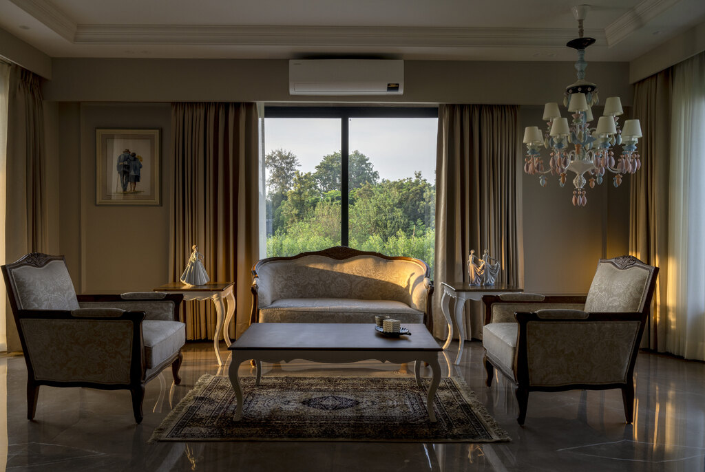 Seating area within a master suite by Pochē Aesthetics