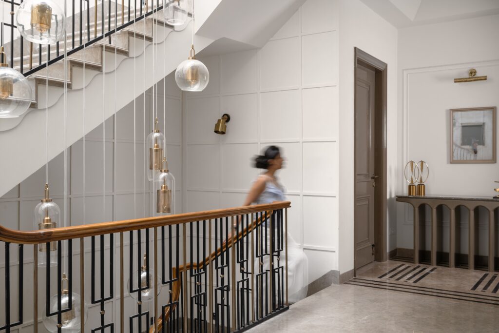 Curved timber staircase with brass balustrade, contemporary interior design
